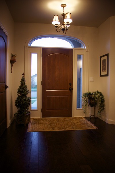 Inspiration for a classic hallway in Other with white walls, dark hardwood flooring, a single front door and a medium wood front door.