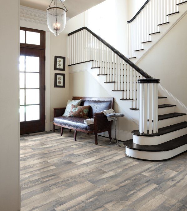 This is an example of a traditional entrance in Phoenix with laminate floors and brown floors.