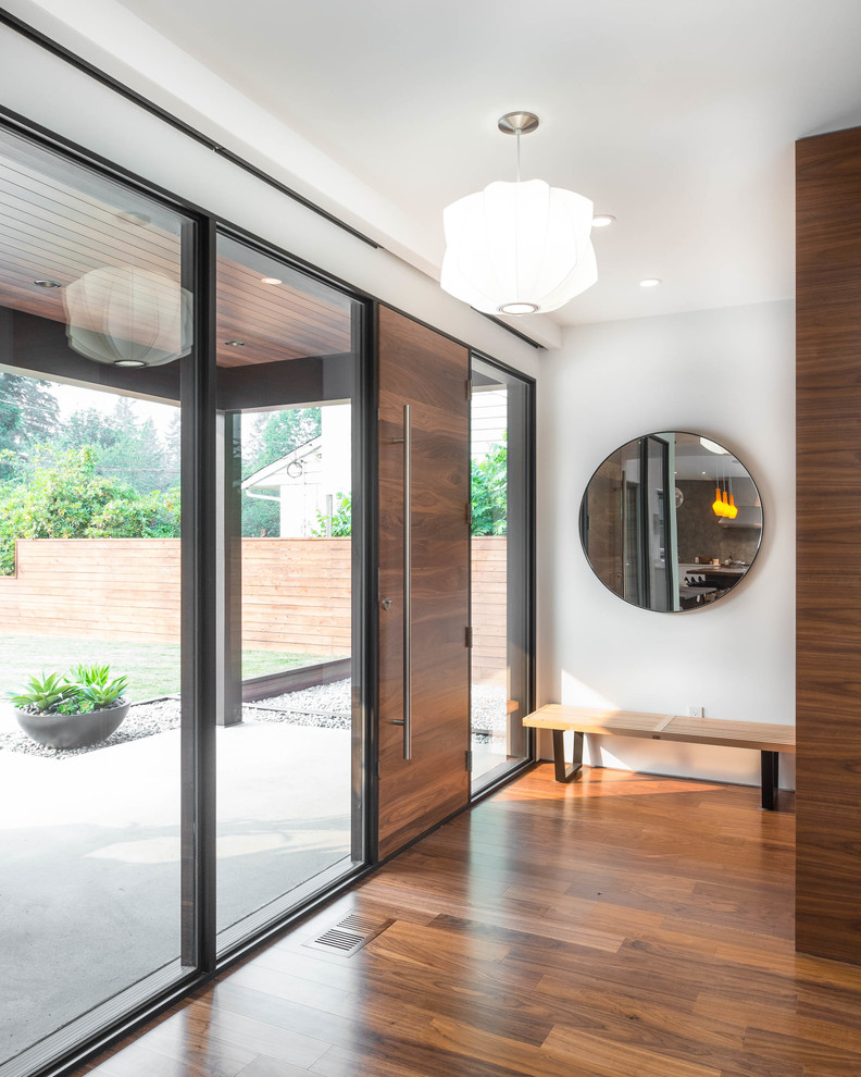 Design ideas for a medium sized retro front door in Vancouver with white walls, medium hardwood flooring, a single front door, a medium wood front door and brown floors.