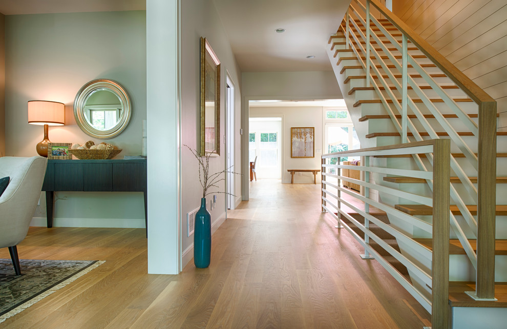 Entryway - coastal light wood floor entryway idea in Minneapolis with white walls and a dark wood front door