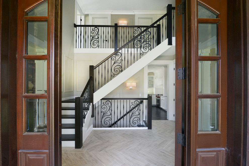 Inspiration for a large traditional foyer in Chicago with beige walls, light hardwood flooring, a single front door, a medium wood front door and grey floors.