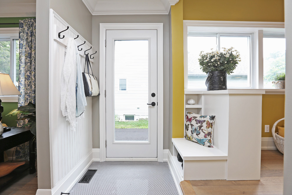 Example of a mid-sized country porcelain tile and gray floor entryway design in Toronto with beige walls and a glass front door