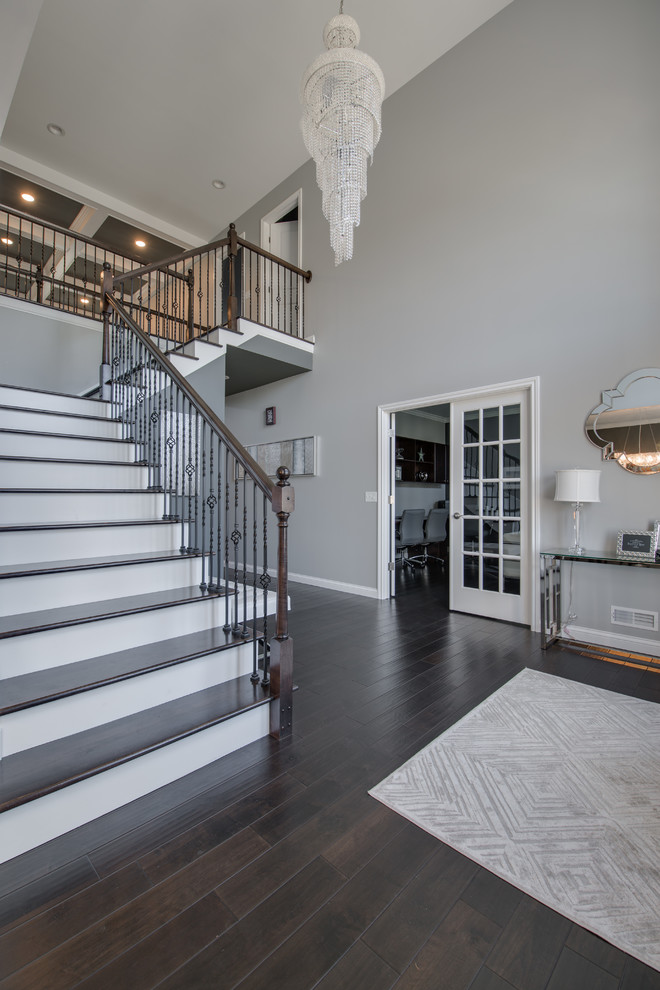 Large transitional dark wood floor and brown floor foyer photo in Grand Rapids with gray walls
