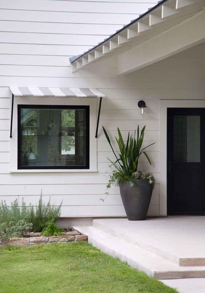 Farmhouse single front door photo in Austin with a black front door