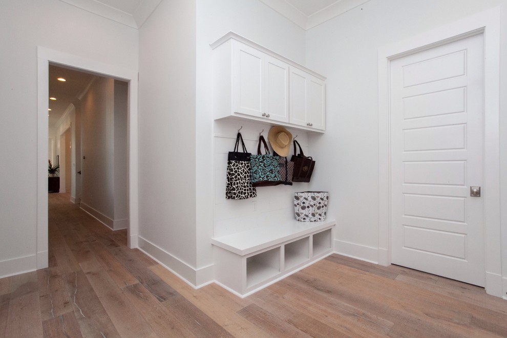 Mid-sized elegant light wood floor entry hall photo in New Orleans with white walls