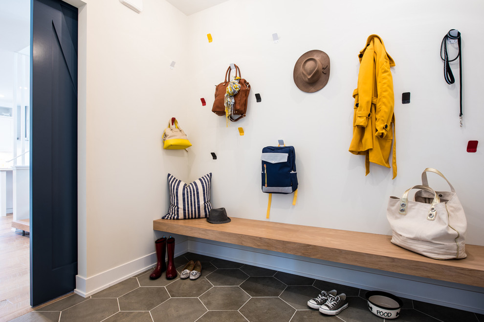 Photo of a traditional boot room in Minneapolis with white walls, ceramic flooring and grey floors.
