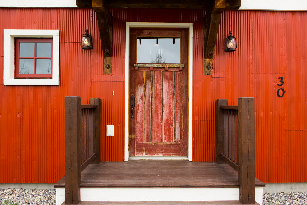 Foto di una porta d'ingresso country con una porta singola e una porta rossa