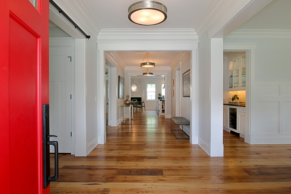 Inspiration for a large farmhouse medium tone wood floor entryway remodel in Chicago with gray walls and a red front door