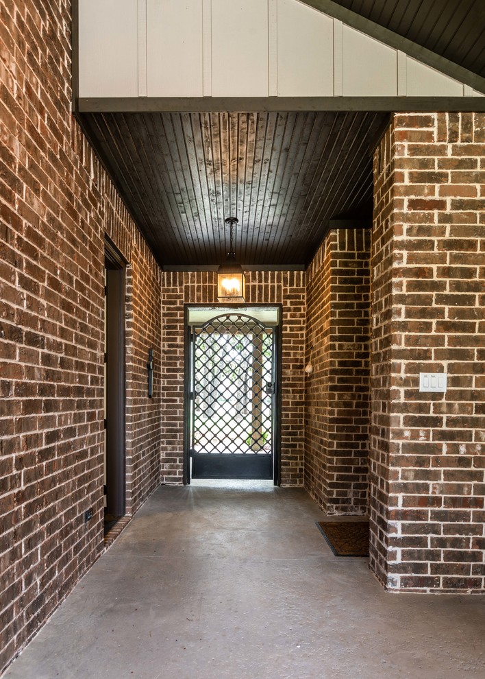 Entryway - large cottage concrete floor and gray floor entryway idea in Dallas with multicolored walls and a metal front door