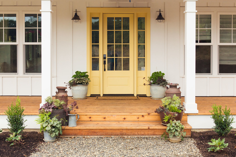 Large farmhouse medium tone wood floor and brown floor entryway photo in Portland with white walls and a yellow front door