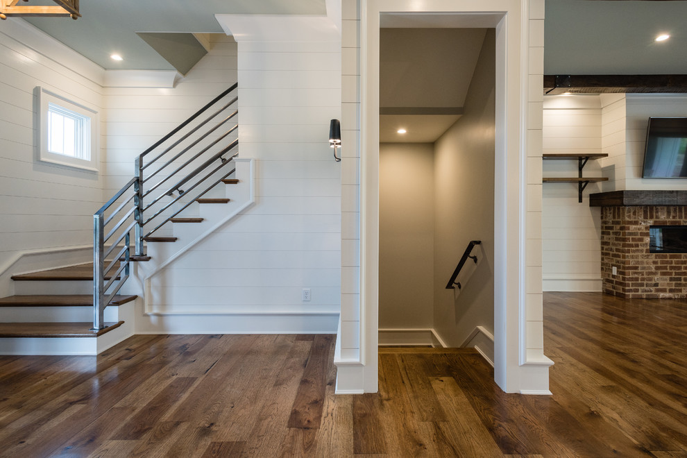 This is an example of a medium sized farmhouse hallway in Atlanta with white walls, dark hardwood flooring, a double front door, a dark wood front door and brown floors.