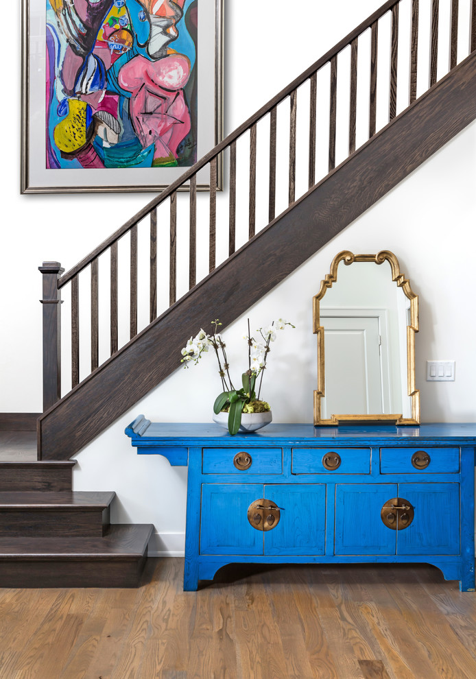 Foyer - mid-sized transitional medium tone wood floor and brown floor foyer idea in Milwaukee with white walls