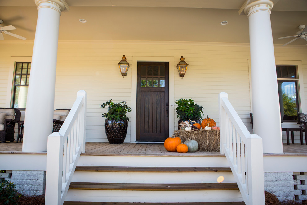 This is an example of a large farmhouse front door in Atlanta with white walls, dark hardwood flooring, a single front door and a dark wood front door.