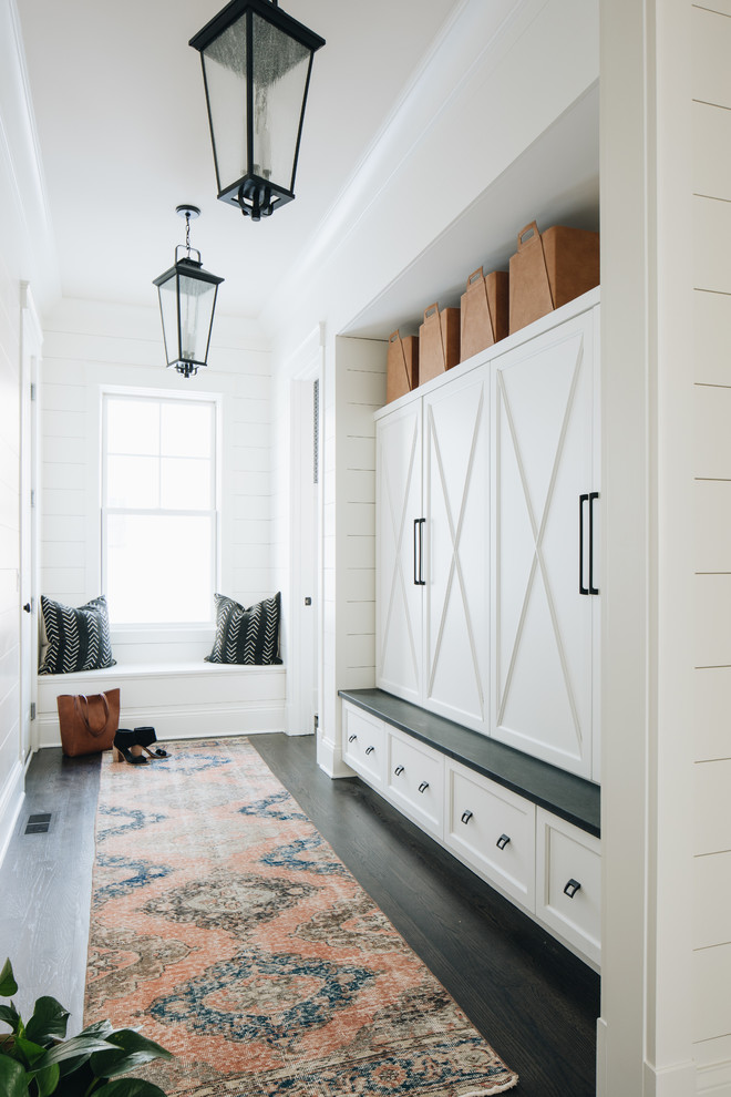 Farmhouse dark wood floor and brown floor mudroom photo in Chicago with white walls
