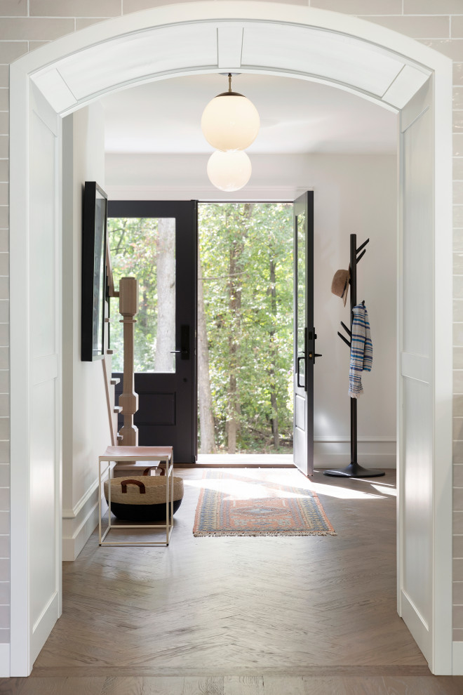 Inspiration for a large traditional entrance in Minneapolis with white walls, medium hardwood flooring, a double front door and brown floors.