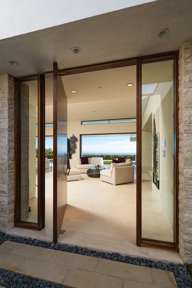 Inspiration for a large contemporary front door in Los Angeles with a pivot front door, a dark wood front door, white walls, porcelain flooring and beige floors.