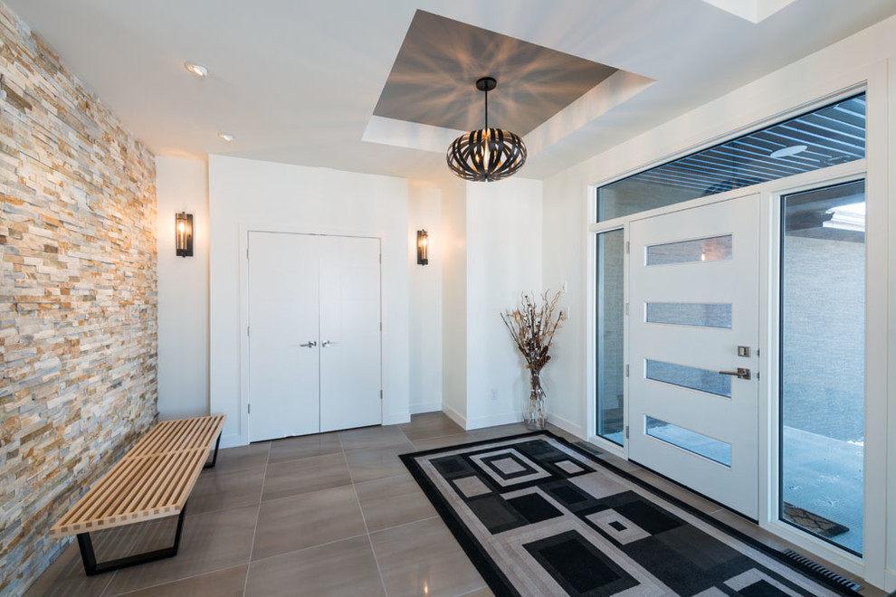 Immagine di un ingresso o corridoio minimalista con pareti bianche, pavimento con piastrelle in ceramica, una porta singola e una porta bianca
