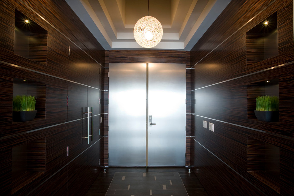 Entryway - mid-sized modern dark wood floor entryway idea in Minneapolis with brown walls and a metal front door