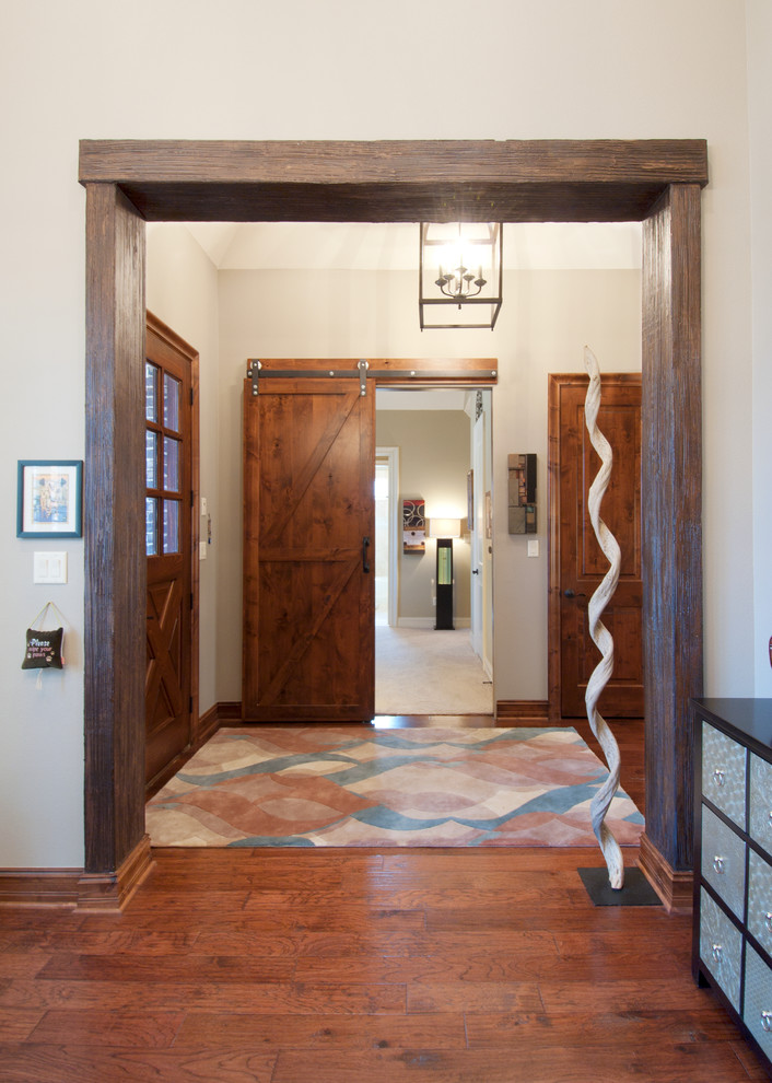 Mittelgroßes Industrial Foyer mit beiger Wandfarbe, braunem Holzboden, Einzeltür und hellbrauner Holzhaustür in Dallas