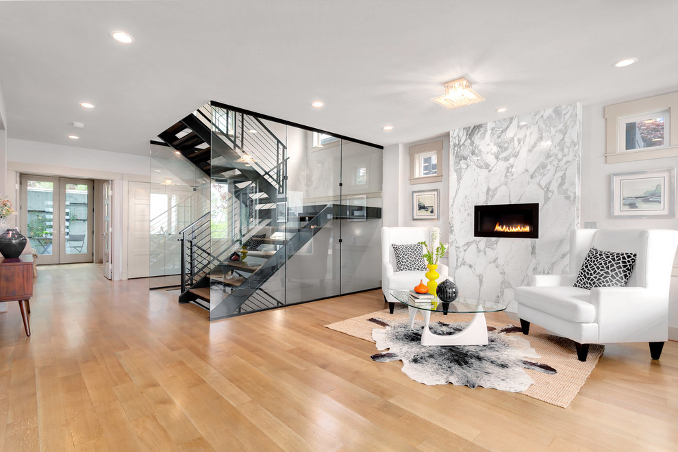 Photo of an expansive modern foyer in Seattle with grey walls and light hardwood flooring.