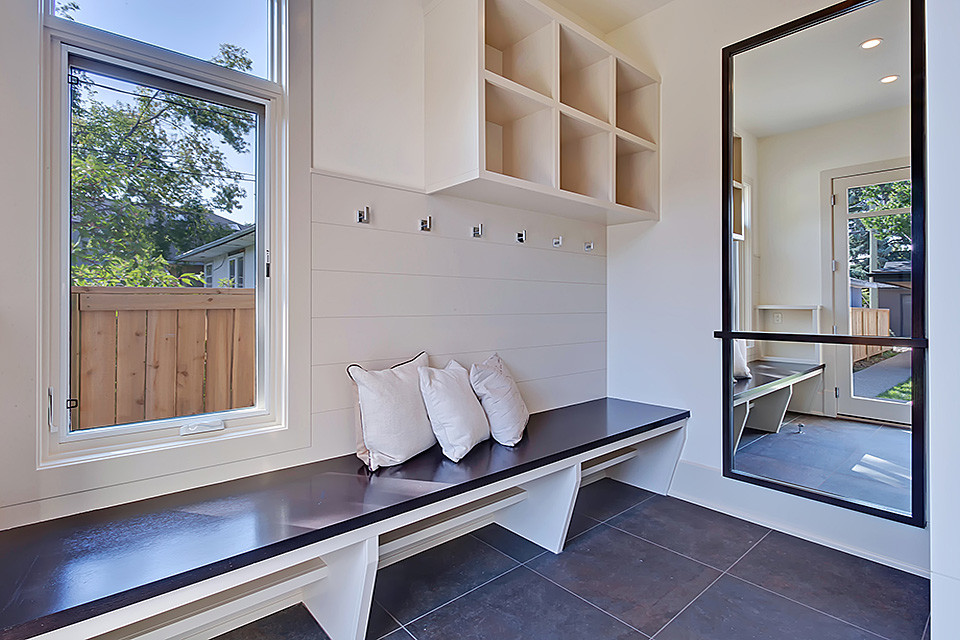 Inspiration for a medium sized contemporary boot room in Calgary with white walls, ceramic flooring, a single front door and a white front door.