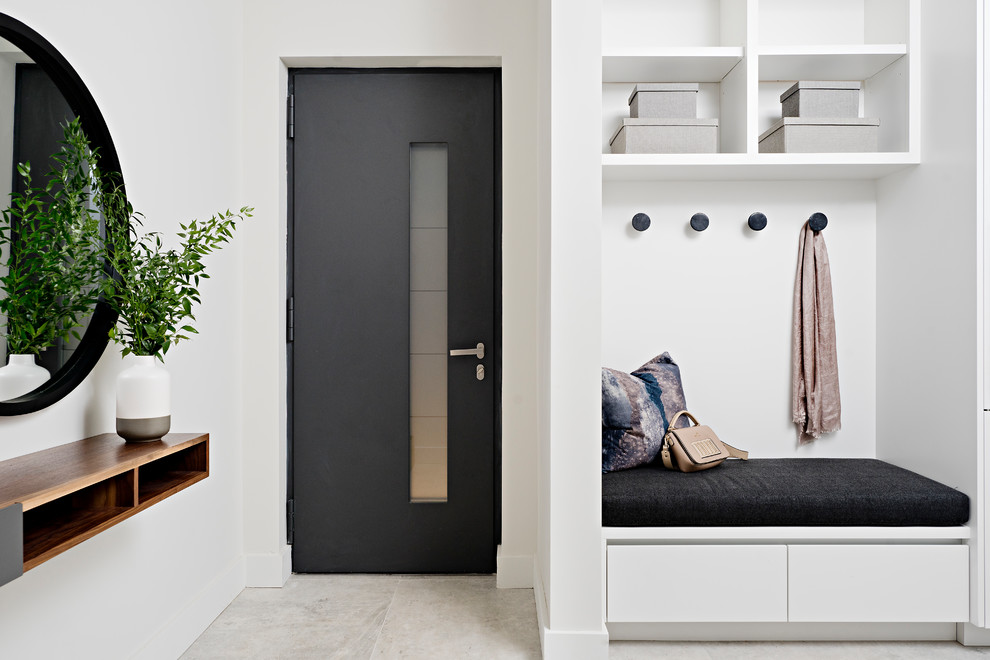 Photo of a large contemporary boot room in Toronto with white walls, porcelain flooring, a single front door, a grey front door and grey floors.