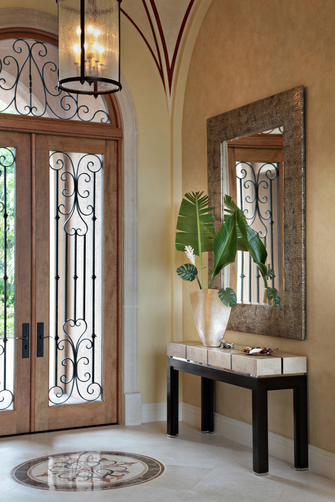 Esempio di una porta d'ingresso mediterranea di medie dimensioni con pareti beige, una porta a due ante, una porta in vetro e pavimento beige