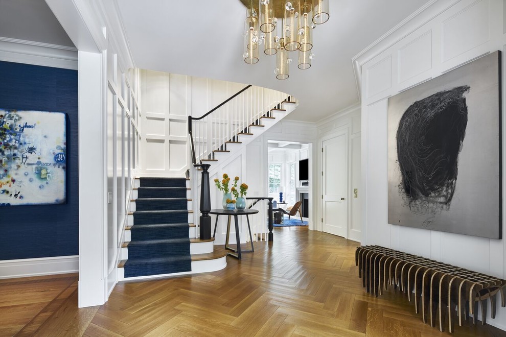 Design ideas for a large classic foyer in New York with medium hardwood flooring, white walls, a double front door, a dark wood front door and brown floors.