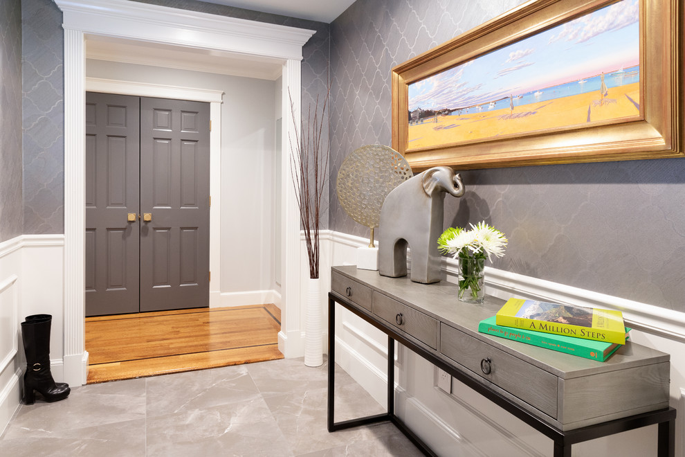 Trendy ceramic tile and gray floor foyer photo in Boston with a gray front door