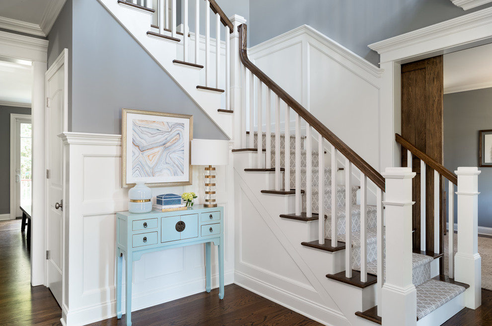 Classic foyer in New York with blue walls, dark hardwood flooring, brown floors and feature lighting.