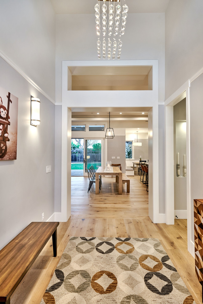 Mid-sized transitional light wood floor entryway photo in San Francisco with gray walls and a medium wood front door