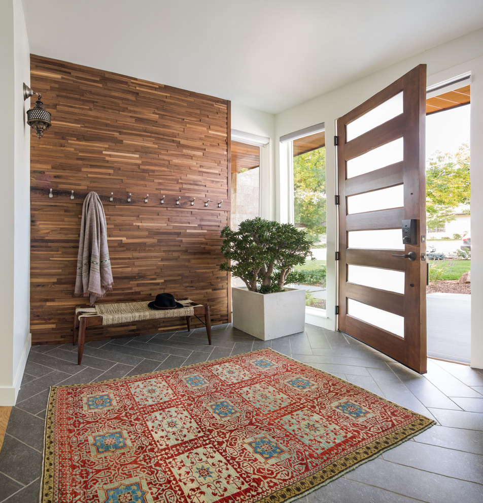 Inspiration for a medium sized contemporary front door in Denver with porcelain flooring, white walls, a single front door, a medium wood front door, grey floors and a feature wall.