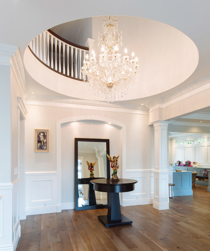 Large contemporary foyer in Vancouver with medium hardwood flooring and beige walls.