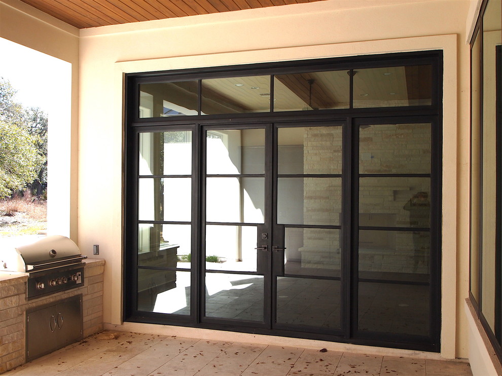 This is an example of a medium sized contemporary entrance in Austin with beige walls, concrete flooring, a double front door and a black front door.