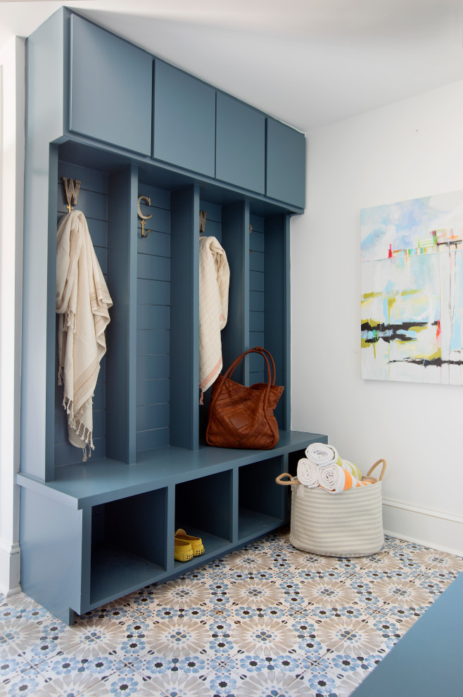 This is an example of a medium sized beach style boot room in Charleston with white walls and multi-coloured floors.