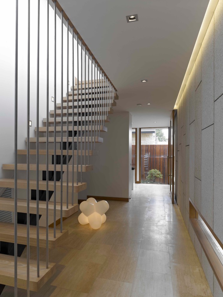 Inspiration for a contemporary hallway in Melbourne with white walls, light hardwood flooring, a single front door and a light wood front door.