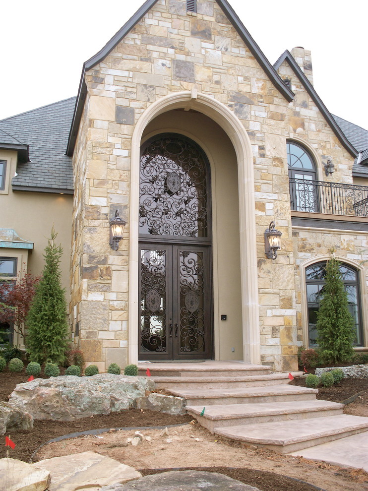 Medium sized traditional front door in Oklahoma City with beige walls, a double front door and a glass front door.