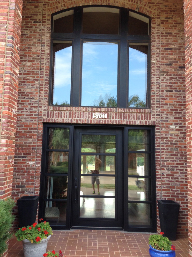 Пример оригинального дизайна: входная дверь среднего размера в классическом стиле с бежевыми стенами, кирпичным полом, одностворчатой входной дверью и металлической входной дверью