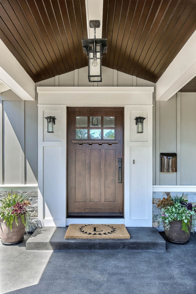 Inspiration for a country concrete floor entryway remodel in San Francisco with gray walls and a dark wood front door
