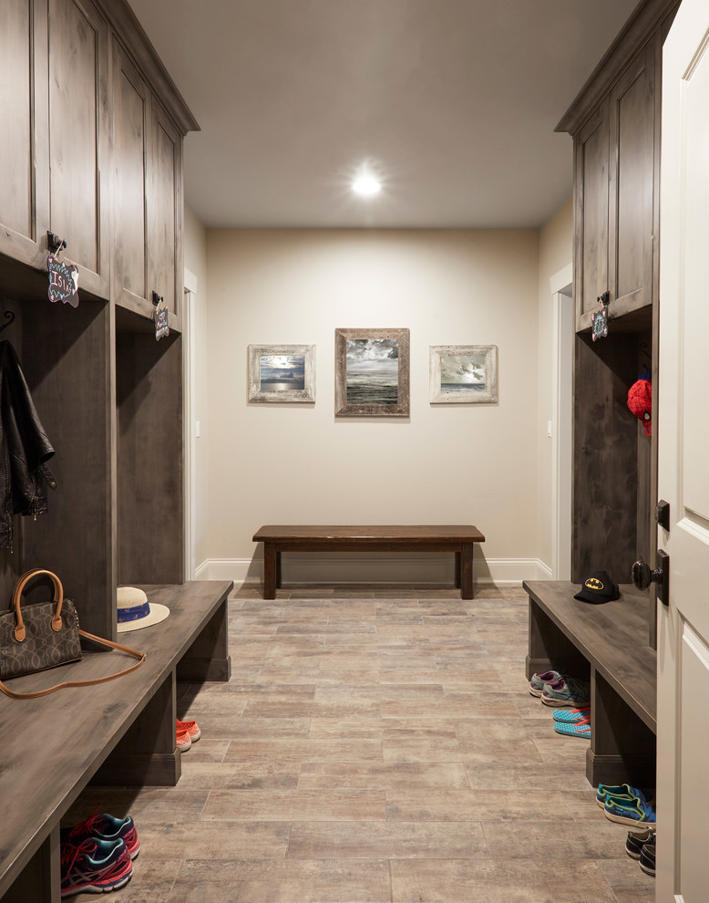 Large transitional porcelain tile and brown floor mudroom photo in Miami with beige walls