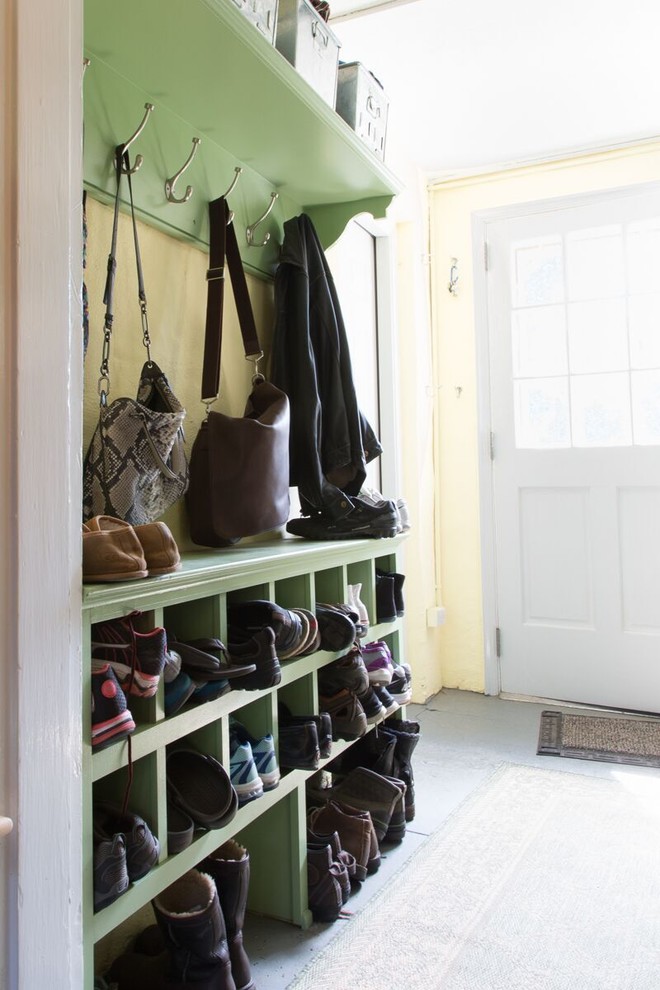 Inspiration for a medium sized classic boot room in Philadelphia with yellow walls, concrete flooring, a single front door and a white front door.