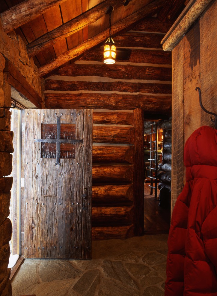 Photo of a rustic boot room in Other with a single front door.