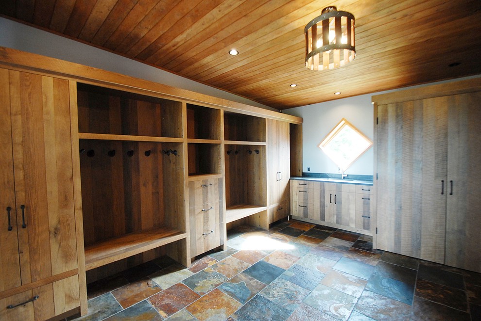 Photo of an expansive rustic boot room in Burlington with grey walls, slate flooring, a single front door, a medium wood front door and multi-coloured floors.