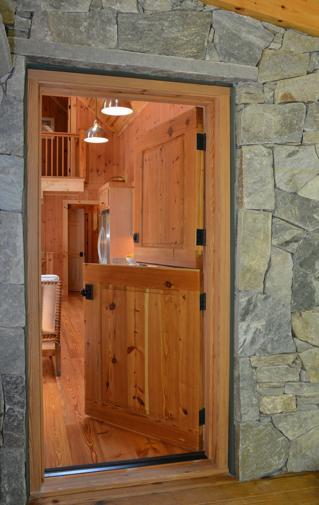 Photo of a rustic entrance in Boston with a stable front door.
