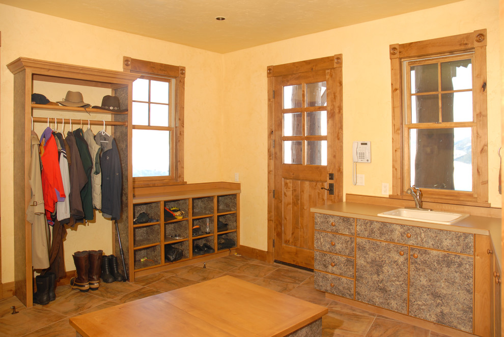 Design ideas for a medium sized rustic boot room in Denver with yellow walls, a single front door and a light wood front door.