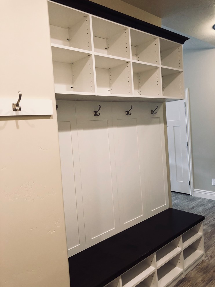 This is an example of a large contemporary boot room in Salt Lake City with beige walls, light hardwood flooring, a double front door, a white front door and brown floors.