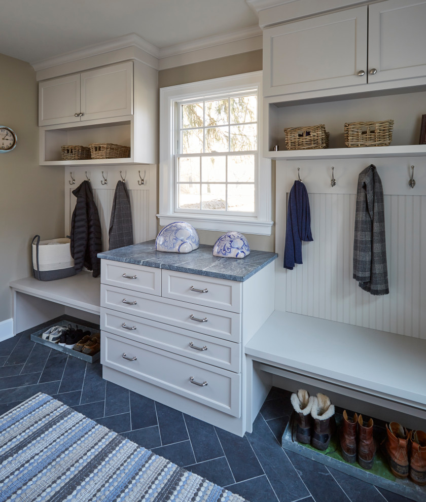 This is an example of a medium sized boot room in Chicago with beige walls, slate flooring, a single front door, a white front door and grey floors.