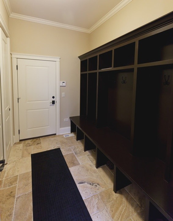 Example of a large classic porcelain tile entryway design in Chicago with beige walls and a white front door