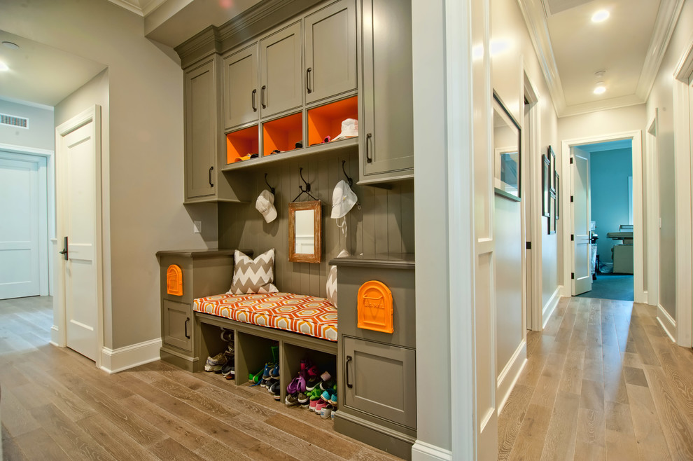 Example of a classic light wood floor mudroom design in Los Angeles with gray walls