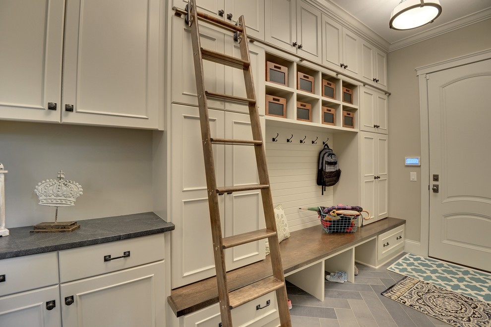 This is an example of a large traditional boot room in Minneapolis with beige walls, a single front door and a white front door.